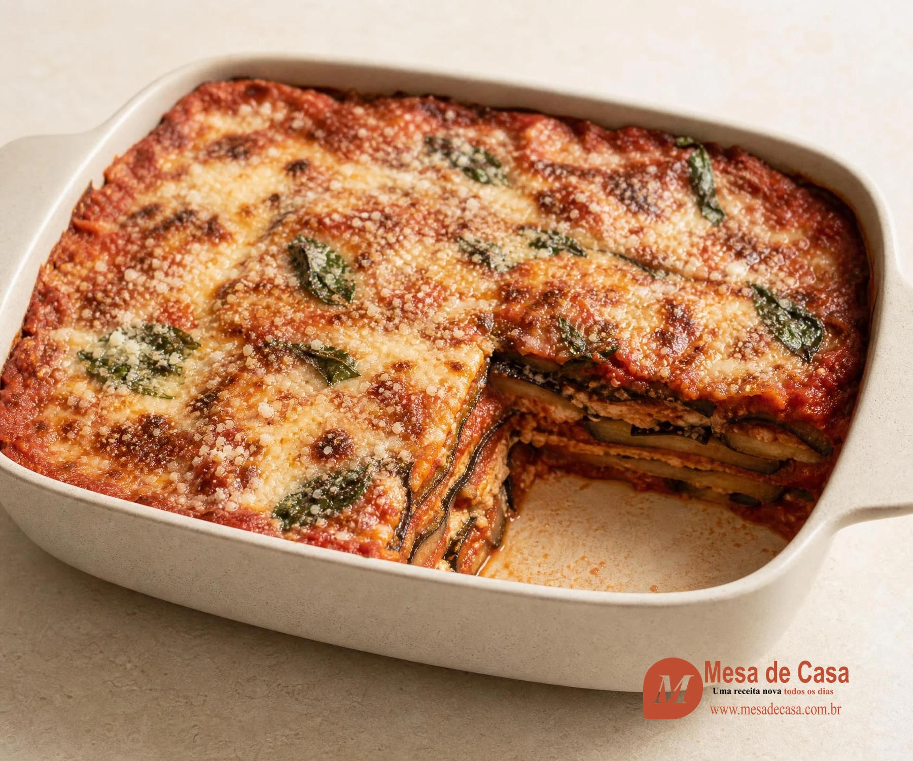 Parmigiana de berinjela em camadas com tomate, parmesão e manjericão